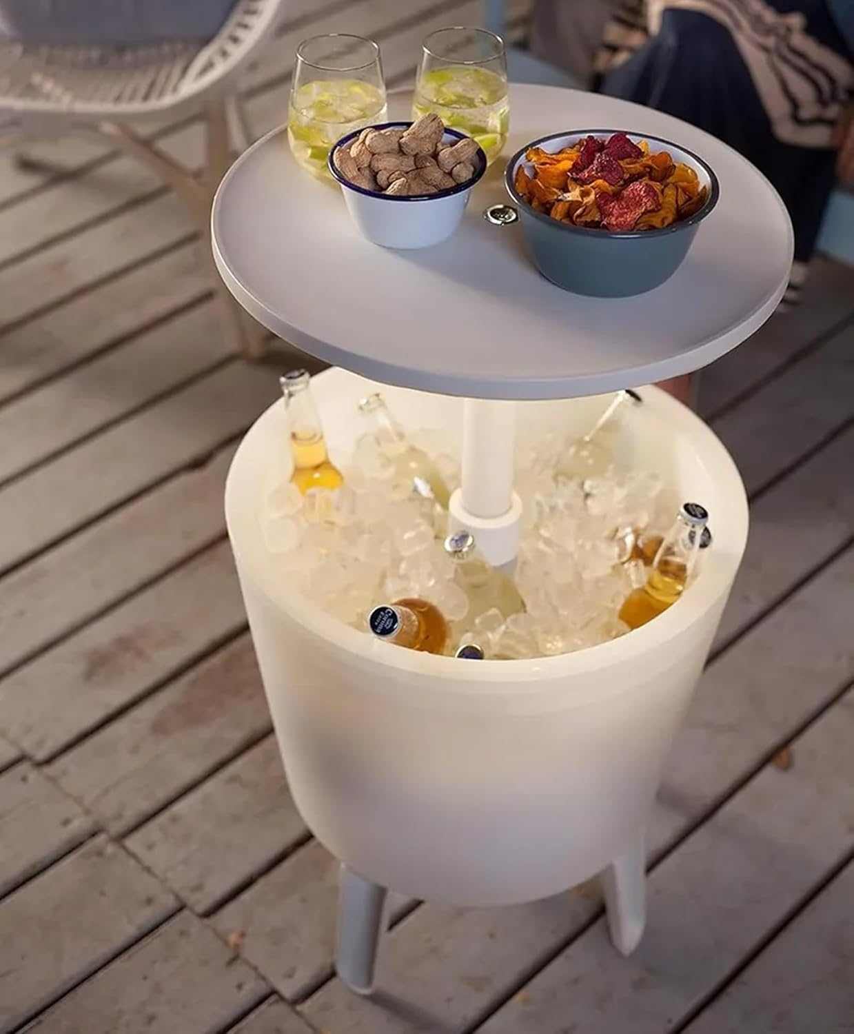 Illuminated outdoor cool bar with built-in ice cooler and glowing tabletop on a patio setting