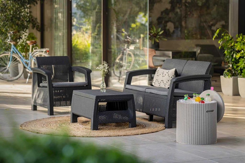 Outdoor Rattan 4 Seater Sofa set with accent table and plush cushions in garden patio setting