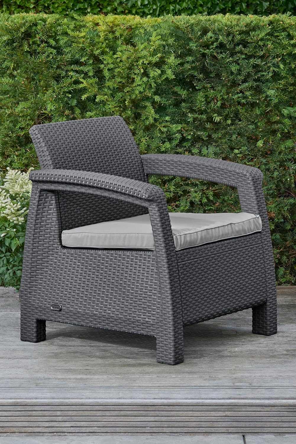 Outdoor rattan 4 seater sofa set with plush cushions and coordinating accent table in garden setting