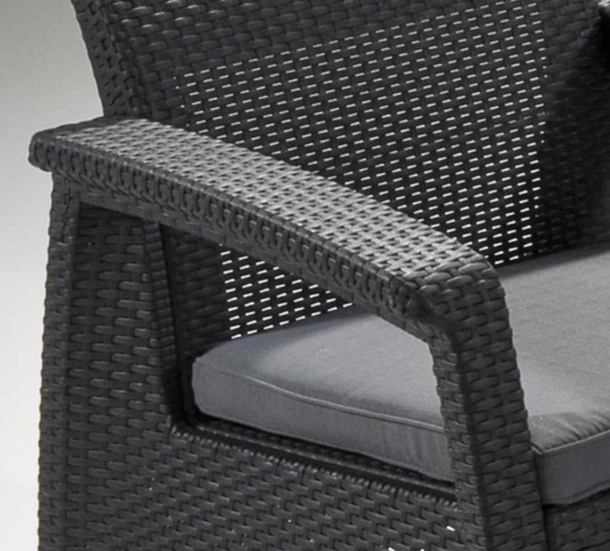 Outdoor rattan 4 seater sofa set with accent table and plush cushions in garden setting