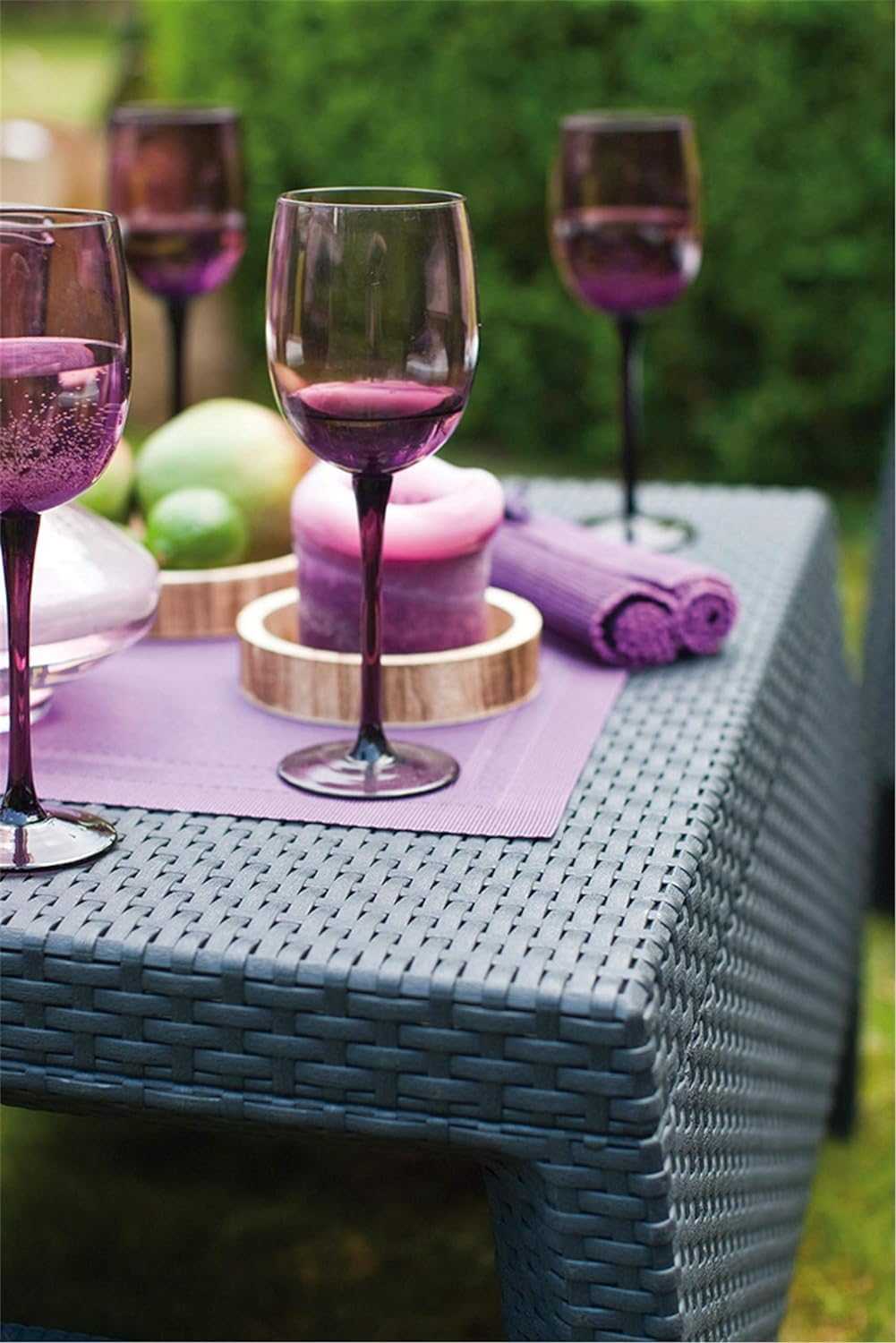 Outdoor Rattan 4 Seater Sofa set with plush cushions and coordinating accent table in garden setting