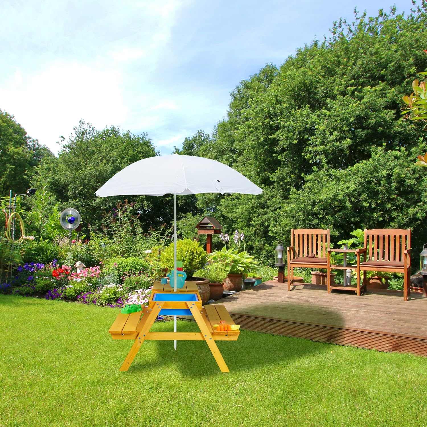 Kids garden picnic table with benches, parasol, and sand and water play tubs outdoors
