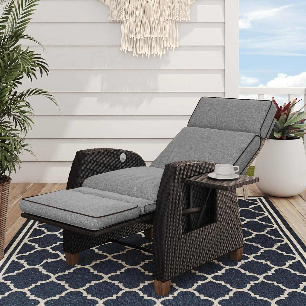 Outdoor reclining wicker lounge chair with cushion and flip-up side table for patio relaxation