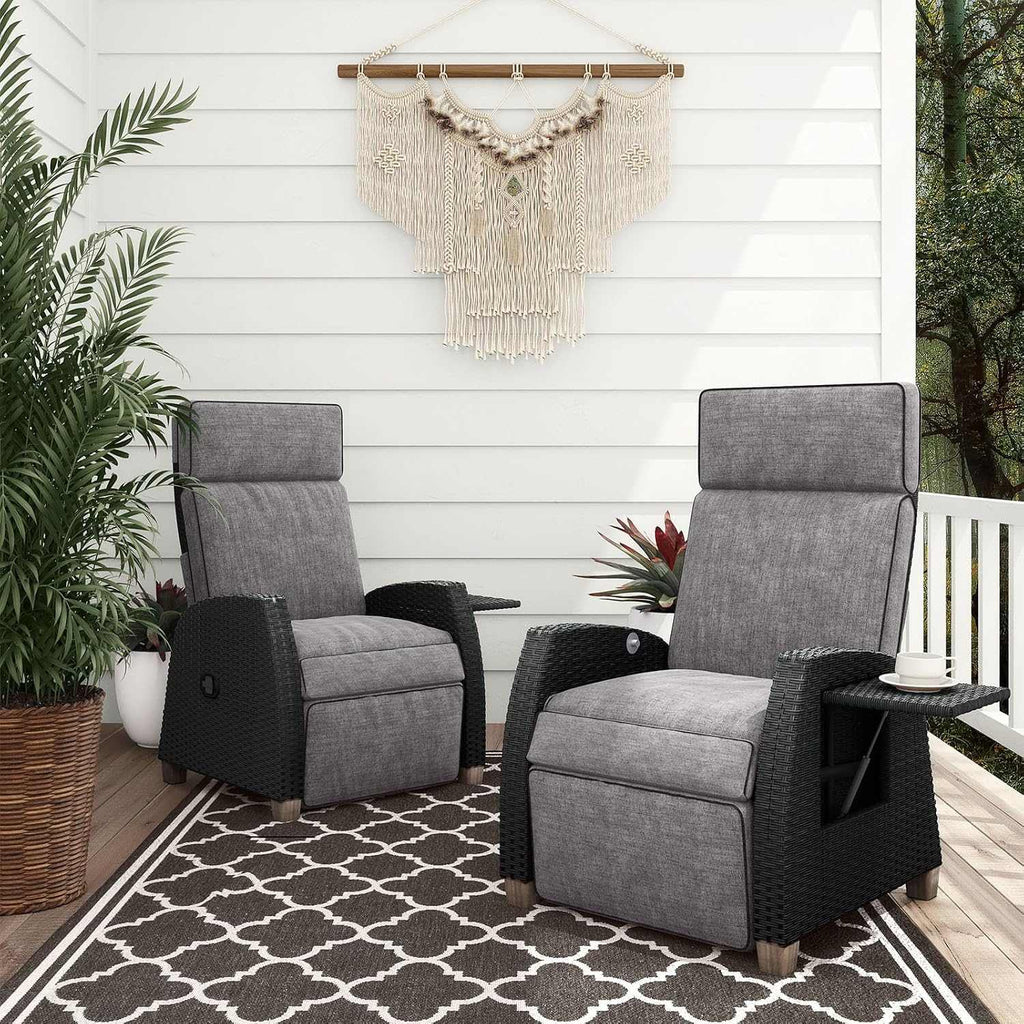 Outdoor reclining wicker lounge chair with thick cushion and flip-up side table on patio
